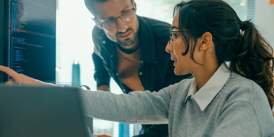 Data science professionals discuss a project in the office.