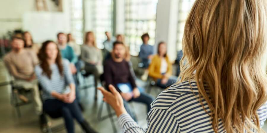 A public health educator speaks to a small community group.