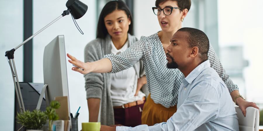 A program manager talks with colleagues.